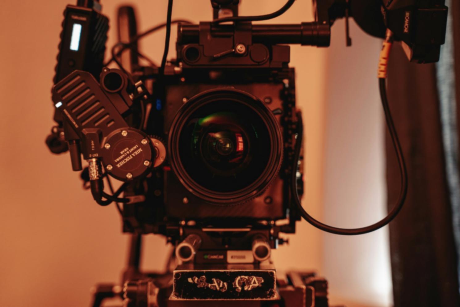 Professional audio editing workspace with multiple monitors showing waveforms and mixing console